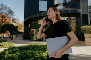 Young lawyer answers her phone outside a Arizona law office