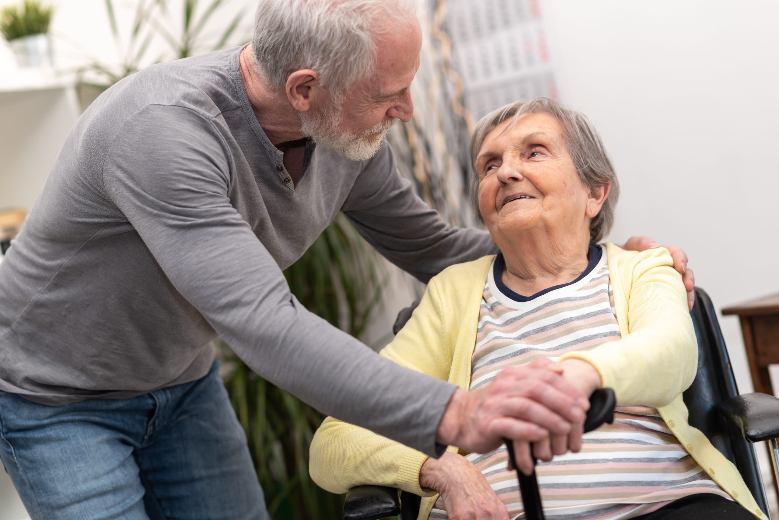 Portrait of elderly woman supported by her son