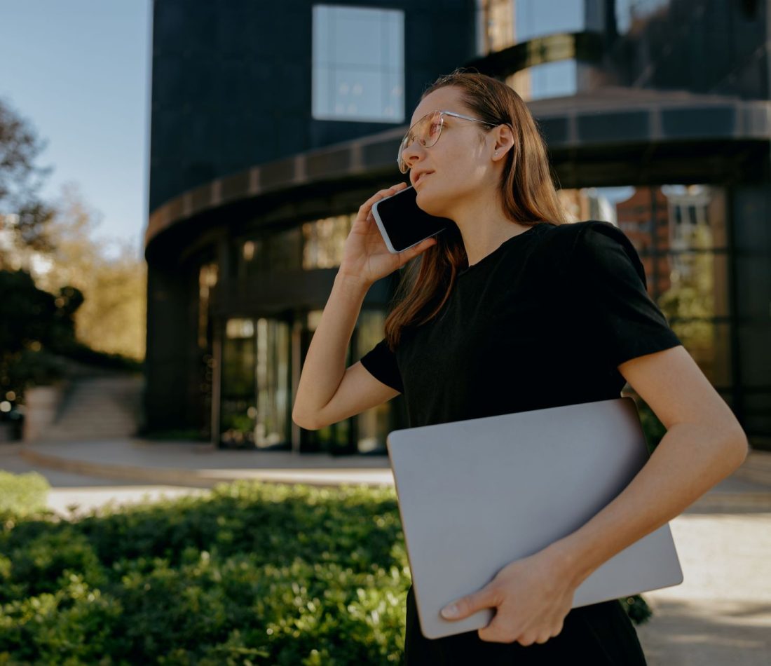 Young lawyer answers her phone outside a Arizona law office