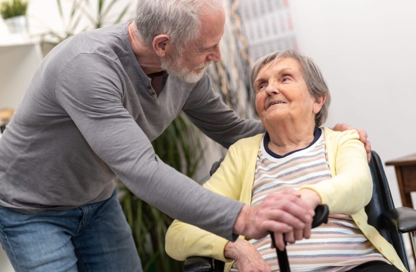 Portrait of elderly woman supported by her son