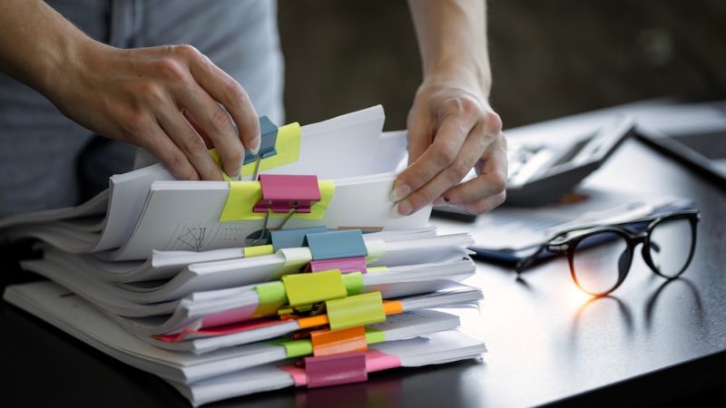 Woman hands going through the paperwork